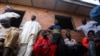 FILE - Parents attend a meeting at the Salihu Tanko Islamic school in Tegina, Niger state, Nigeria, Aug. 10, 2021. Gunmen raided the school May 30, kidnapping 136 students.