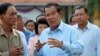 FILE - Cambodian Prime Minister Hun Sen, center, of ruling Cambodian People's Party speaks after voting in the senate election at Takhmau polling station in Kandal province, southeast of Phnom Penh, Cambodia, Feb. 25, 2018.