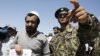 An Afghan soldier, right, escorts a released prisoner, Mohammad Karim, following a hand over ceremony of U.S.- run prison to Afghan government in Bagram north of Kabul, Afghanistan, Sept. 10, 2012. 