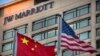 FILE - Chinese and American flags fly outside of a JW Marriott hotel in Beijing, Jan. 11, 2018. 