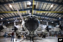 A front view of the Lockheed Orion WP3D aircraft loaded with sophisticated chemistry instruments.