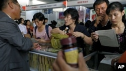 A police officer scuffles with a protester during clashes in Lahore, Pakistan. Police clashed with followers of an anti-Taliban cleric critical of the government in the eastern city, leaving at least seven people killed, officials said.