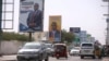 Motorists drive along a street with the campaign billboards of Somalia's Presidential candidates in Somalia's capital Mogadishu, Feb. 6, 2017.