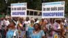 FILE - Demonstrators carry banners as they take part in a march voicing their opposition to independence or more autonomy for the anglophone regions, in Douala, Cameroon, Oct. 1, 2017.
