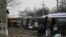 Buses wait along a road while travelling in the direction of the village of Debaltseve, Feb. 6, 2015.