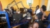 Malawi Capital Radio presenter Madalitso Phiri hosts a panel discussion with studio guests. Malawi media houses say implemention of the Access to Information Law will make news-gathering much easier. (Lameck Masina/VOA)