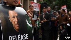 FILE - A supporter of jailed former prime minister Imran Khan holds a placard during a protest rally in Sydney on Aug. 4, 2024, demanding Khan's release from jail.