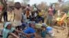 FILE - Refugees from Central Africa sit in the eastern Cameroonian village of Gado Badzere, near the city of Garoua-Boulai, not far from the border with Central Africa, March 13, 2014. 
