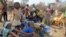 FILE - Refugees from Central Africa sit in the eastern Cameroonian village of Gado Badzere, near the city of Garoua-Boulai, not far from the border with Central Africa, March 13, 2014. 