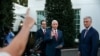 Vice President Mike Pence, center, with Treasury Secretary Steven Mnuchin, left, and White House national security adviser Robert O'Brien, waves as he turns to leave after speaking to reporters.