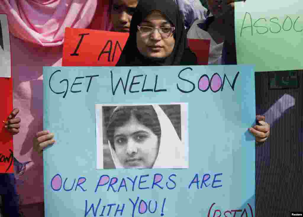A student holds a placard with a picture of schoolgirl Malala Yousufzai.