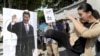 An activist kicks a portrait of Chinese President Xi Jinping during a protest against the upcoming meeting between Taiwan's President Ma Ying-jeou and Chinese President Xi Jinping, in front of the Presidential Office in Taipei, Taiwan, Nov. 5, 2015.