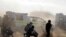 Policemen in teargas and dust open fire on striking miners at the Lonmin Platinum Mine near Rustenburg, South Africa, August 16, 2012. 