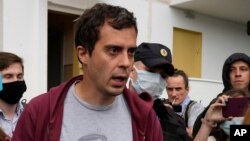 Pemimpin redaksi situs “The Insider,” Roman Dobrokhotov dikelilingi oleh polisi Rusia dan beberapa jurnalis di Moskow, Rabu (28/7). 