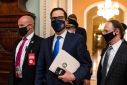 Treasury Secretary Steven Mnuchin makes a brief comment as he leaves the Capitol, Sept. 30, 2020, in Washington. Mnuchin earlier met with House Speaker Nancy Pelosi of California.