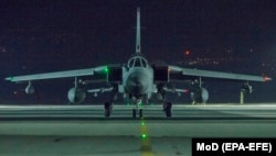 CYPRUS -- A handout photo made available by the British Ministry of Defence (MoD) showing a British Royal Air Force (RAF) Tornado pilot taxis his aircraft into its hangar after landing at RAF Akrotiri, Cyprus, 14 April 2018.