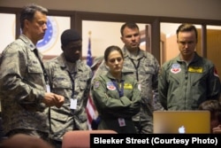 Gavin Hood (left) as Lt. Col. Ed Walsh, Phoebe Fox (center) as Carrie Gershon, and Aaron Paul (right) as Steve Watts in EYE IN THE SKY, a Bleecker Street release.