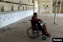 FILE - A patient in a wheelchair waits at a medical center in Karachi, Pakistan, Sept. 17, 2015. No data has been collected on the number of disabled in Pakistan since 1998.