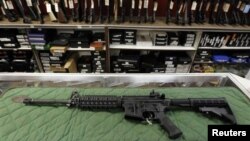 FILE - An AR-15 style rifle is displayed at the Firing-Line indoor range and gun shop, in Aurora, Colorado. A school district in the western U.S. state of Colorado is set to arm its security personnel with semi-automatic rifles similar to those used by United States military.