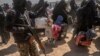 FILE - Women and children evacuated from the Islamic State group's holdout of Baghuz arrive at a screening area held by the U.S.-backed Syrian Democratic Forces, in the eastern Syrian province of Deir el-Zour, March 6, 2019.