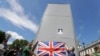 Members of far-right Football Lads Alliance hold a British flag in front of a protective covering surrounding the statue of former British Prime Minister Sir Winston Churchill in Parliament Square, central London, June 13, 2020.