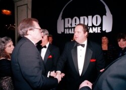 FILE - Radio host Rush Limbaugh, right, is congratulated by Larry King at the Radio Hall of Fame induction ceremony at the Museum of Broadcast Communications in Chicago, Ill., Nov. 7, 1993.