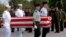 FILE PHOTO - Four U.S. servicemen carry a coffin containing the remains of U.S. servicemen from the Vietnam War era to an American military transport aircraft as U.S. pilots salute during a repatriation ceremony at the Phnom Penh airport Monday, Feb. 16, 1998. The remains discovered early this month have been linked to the crash of a U.S. Huey helicopter which flew into Cambodia with four crewmen on a rescue mission in March 1970 to pick up a special operations team in trouble. They will be brought to the Central Identification Laboratory in Hawaii for forensic analysis. (AP Photo/Ou Neakiry)