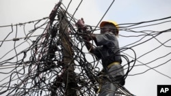An official of Nigeria Power works on power lines in Lagos, Nigeria, July 22, 2011. 
