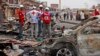 FILE - Red Cross personnel search for remains at the site of one of Tuesday's car bombs in Jos, Nigeria, May 21, 2014.
