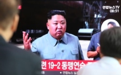 People watch a TV showing a file image of North Korean leader Kim Jong Un during a news program at the Seoul Railway Station in Seoul, South Korea, July 25, 2019.