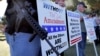 FILE - Gun rights supporters stand outside the Capitol in Phoenix during a Guns Across America rally. 