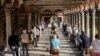 Faithful attend a Mass in the courtyard of La Fontana church, in Milan, Italy, May 18, 2020. 