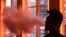 FILE - A patron exhales vapor from an e-cigarette at the Henley Vaporium in New York