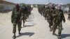 FILE - Members of Somalia's al-Shabab militant group patrol on the outskirts of Mogadishu, Somalia, March 5, 2012. 