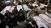 Shi'ite Muslims display the unburied coffins of victims of Thursday's twin bomb attack during a sit-in in Quetta, January 12, 2013.