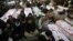 Shi'ite Muslims display the unburied coffins of victims of Thursday's twin bomb attack during a sit-in in Quetta, January 12, 2013.