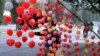 A vendor arranges heart-shaped balloons along the roadside to attract customers ahead of Valentine's Day, in Lahore, Pakistan, Feb. 13, 2016.