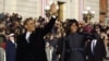 President Barack Obama and first lady Michelle Obama waves as they walk down Pennsylvania Avenue near the White House during the Inauguration parade, Jan. 21, 2013. 