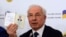 Ukraine's former prime minister, Mykola Azarov, displays his Ukrainian internal passport at a press conference in Moscow, August 3, 2015