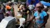 Women collect water at the Chaquelane resettlement camp near the flood hit town of Chokwe, in southern Mozambique, February 7, 2013. 