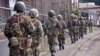 Liberian soldiers walk through streets to prevent panic as fears of the deadly Ebola virus spread in the city of Monrovia, Liberia, Friday, Aug 1, 2014. U.S. health officials warned Americans not to travel to the three West African countries hit by the wo