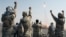 FILE - Members of the Iranian Revolutionary Guard celebrate after launching a missile during maneuvers in an undisclosed location in Iran, July 3, 2012.
