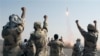 FILE - Iranian Revolutionary Guards celebrate after a missile is launched in Iran, July 3, 2012. Kurdish rebels on Friday clashed with Iran's Revolutionary Guards for a second consecutive day in a border area between Iraq and Iran.