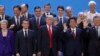 President Donald Trump, front center, stands with other world leaders as they pose for a group picture at the start of the G-20 Leader's Summit inside the Costa Salguero Center in Buenos Aires, Argentina, Nov. 30, 2018. From left, front, are Britain's Pri