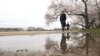 Visitors walk by cherry blossom trees in full bloom at the Tidal Basin in Washington, DC, Thursday, March 19, 2020. 