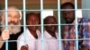 Pastor Hassan Abduraheem, second from left, is shown in prison in Sudan. 