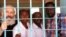 Pastor Hassan Abduraheem, second from left, is shown in prison in Sudan. 