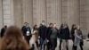 A man wearing a face mask walks past the Bank of England in London, March 4, 2020.