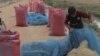 A farmer is seen bagging rice along a road in Banteay Meanchey province, Cambodia, February 23, 2019. 