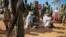 FILE - In this photo released by the African Union-United Nations Information Support Team, alleged al-Shabab members are blindfolded and guarded in Kismayo, southern Somalia on Oct. 3, 2012.